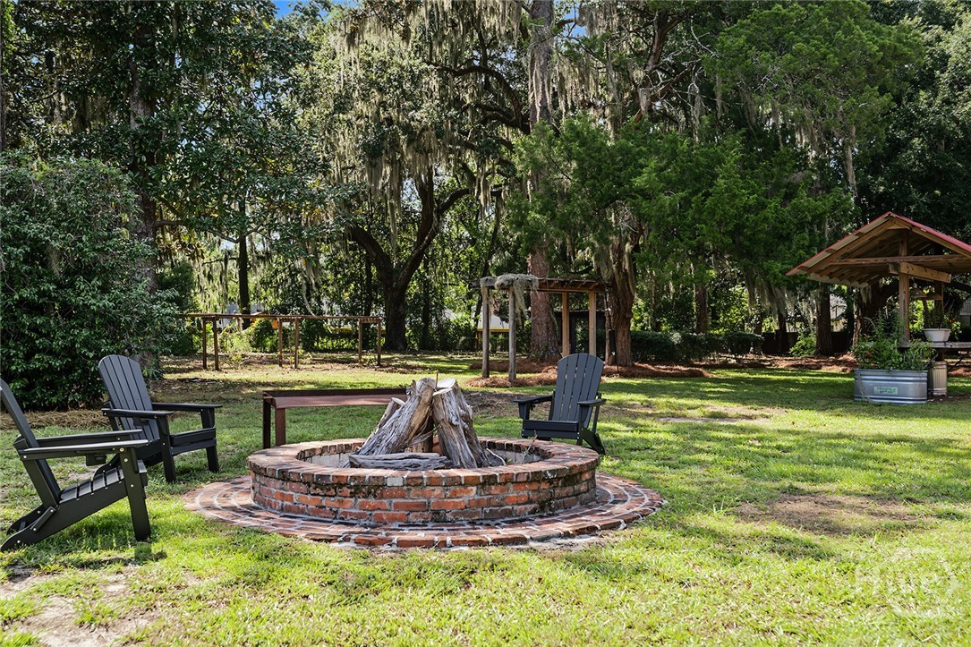 5909 La Roche Avenue Savannah, GA 31406 - Photo 52 of 57 Oyster pit, oyster shucking station, garden with raised beds, and chicken coop