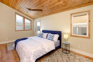 a bedroom with a bed and windows