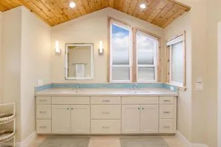 a bathroom with a sink vanity and mirror
