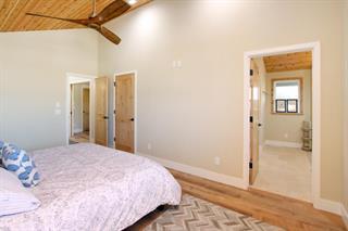 2395 Delaware, Unit 167 Santa Cruz, CA 95060 - Photo 17 of 33 a bedroom with a bed and a glass door shower