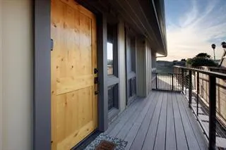 a view of balcony with wooden floor