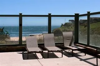 a view of a living room with furniture and floor to ceiling window