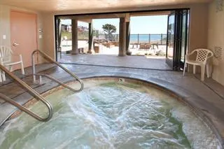 a view of a swimming pool and dining room