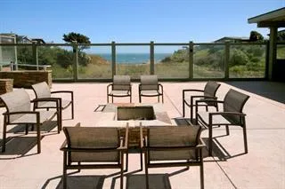 a backyard of a house with potted plants and wooden fence