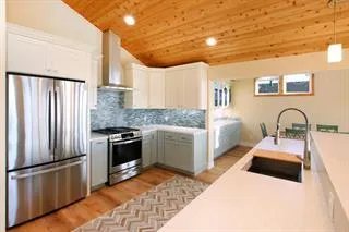 a kitchen with stainless steel appliances granite countertop a refrigerator sink and stove
