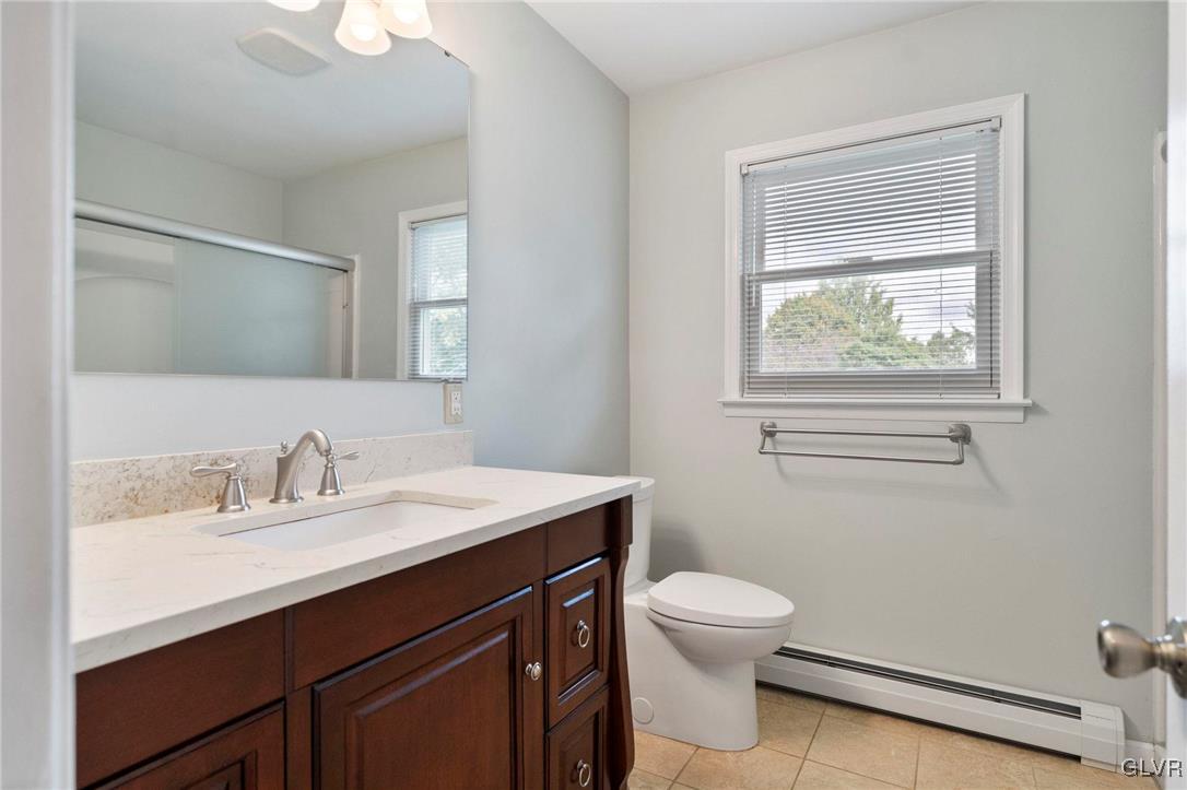 3920 Hemlock Place Bethlehem, PA 18017 - Photo 21 of 39 a bathroom with a toilet a sink a mirror and a window
