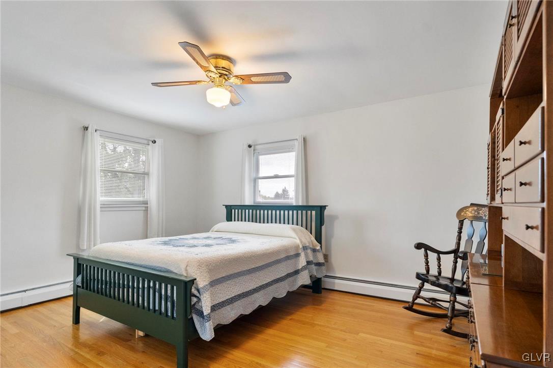 3920 Hemlock Place Bethlehem, PA 18017 - Photo 25 of 39 a bedroom with a bed and a chandelier