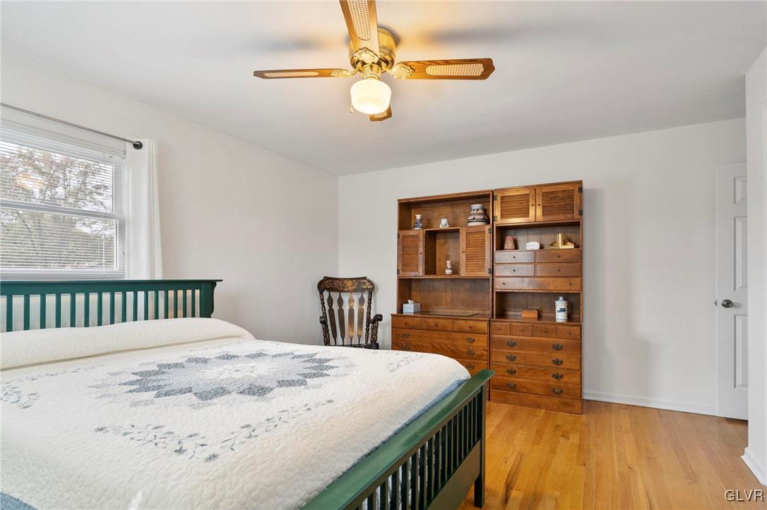 3920 Hemlock Place Bethlehem, PA 18017 - Photo 26 of 39 a bedroom with a bed a table and painting on the wall