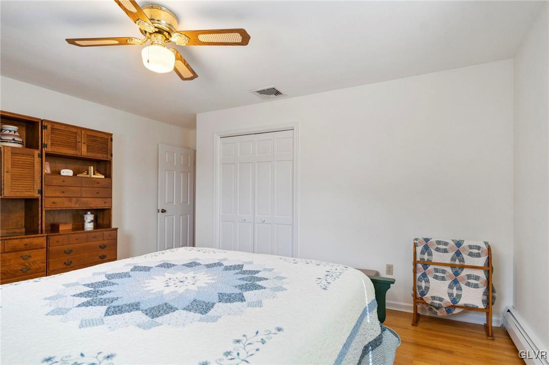 3920 Hemlock Place Bethlehem, PA 18017 - Photo 27 of 39 a bedroom with a bed and wooden floor