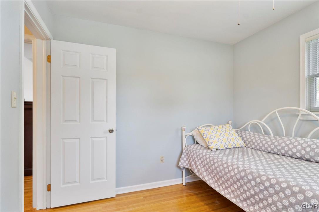 3920 Hemlock Place Bethlehem, PA 18017 - Photo 29 of 39 a bedroom with a bed and wooden floor