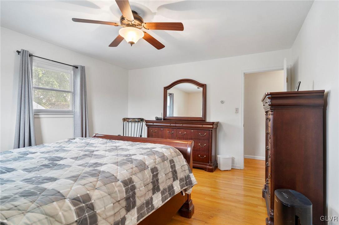 3920 Hemlock Place Bethlehem, PA 18017 - Photo 32 of 39 a bedroom with a bed and a chandelier