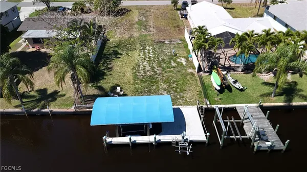 an aerial view of a house with swimming pool and patio