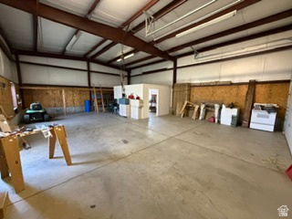 588 North 4500 West West Point, UT 84015 - Photo 43 of 61 Spacious industrial interior featuring a concrete floor, exposed steel beams, and high ceilings with fluorescent lighting