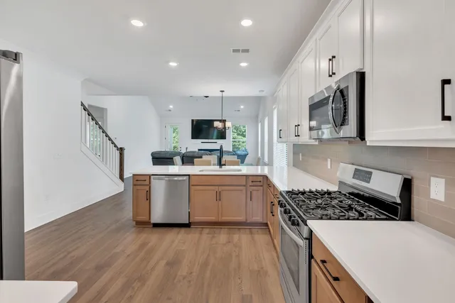 a kitchen with stove and cabinets
