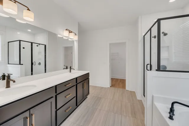 a spacious bathroom with a double vanity sink and a mirror