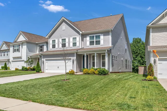 a front view of a house with garden and porch