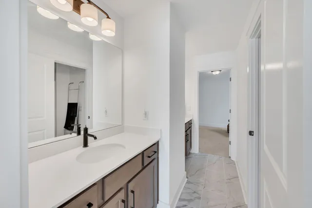 a bathroom with a granite countertop toilet and a shower