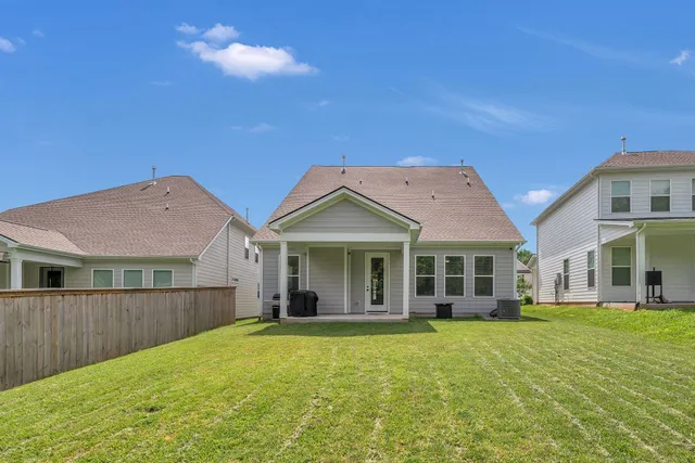 an aerial view of a swimming pool with lawn chairs and iron fence