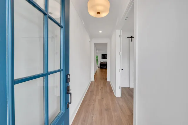 a view of a hallway with wooden floor