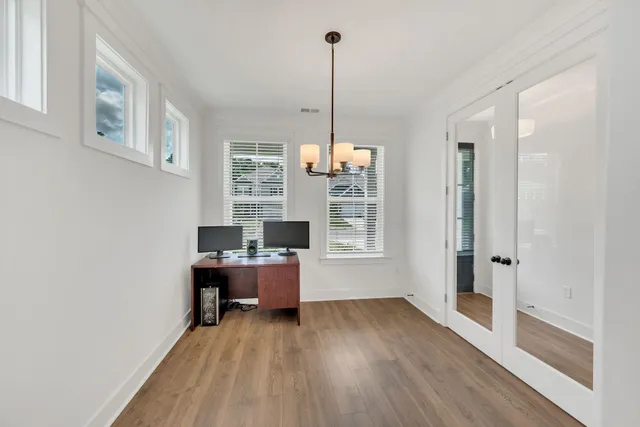 a view of a workspace with furniture and window
