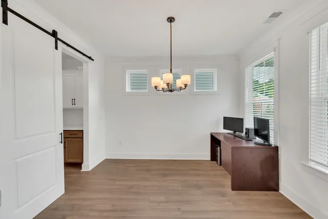 a view of a room with wooden floor and windows