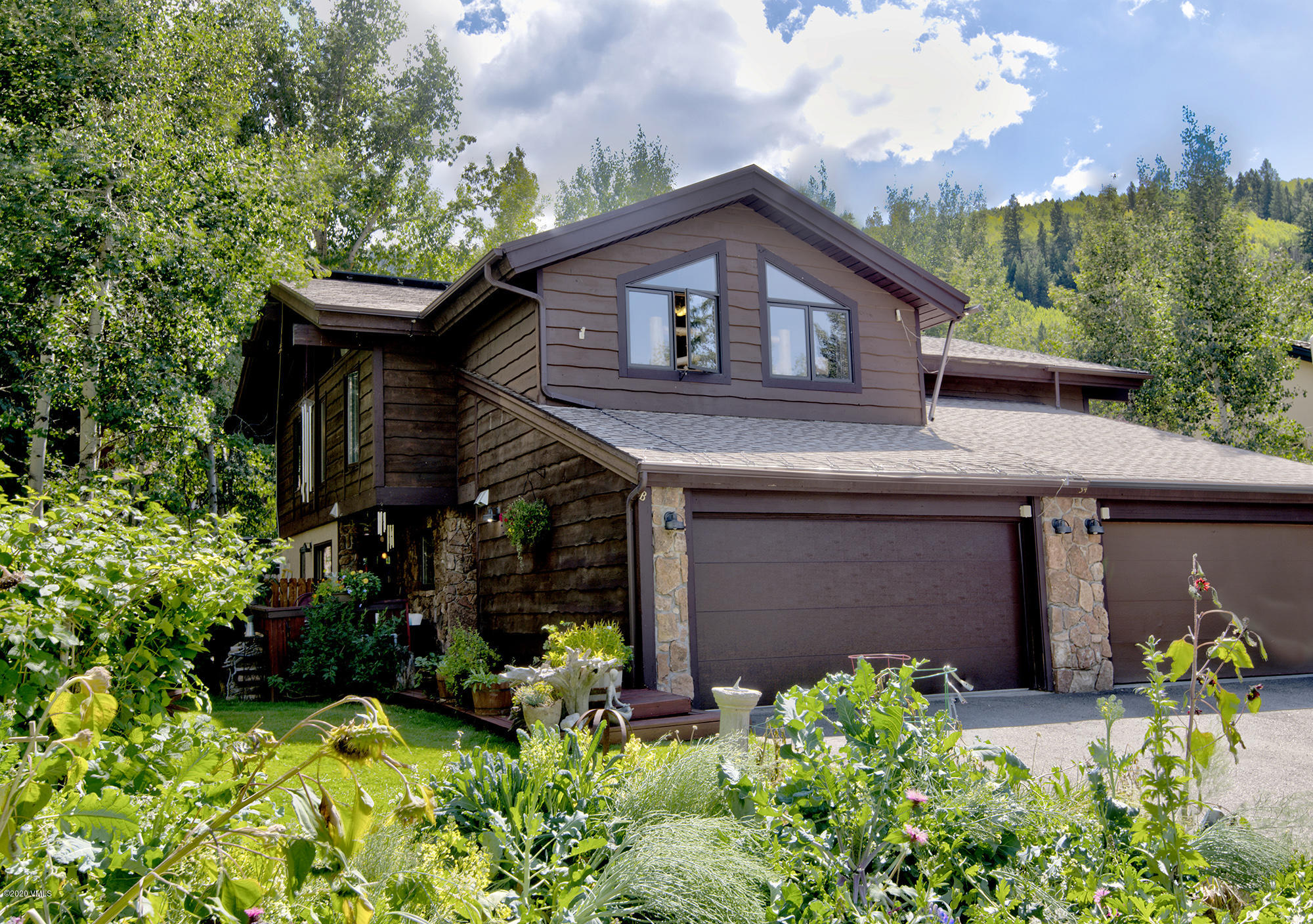 34 Beaver Road, Unit B Avon, CO 81620 - Photo 1 of 34 a front view of a house with a yard