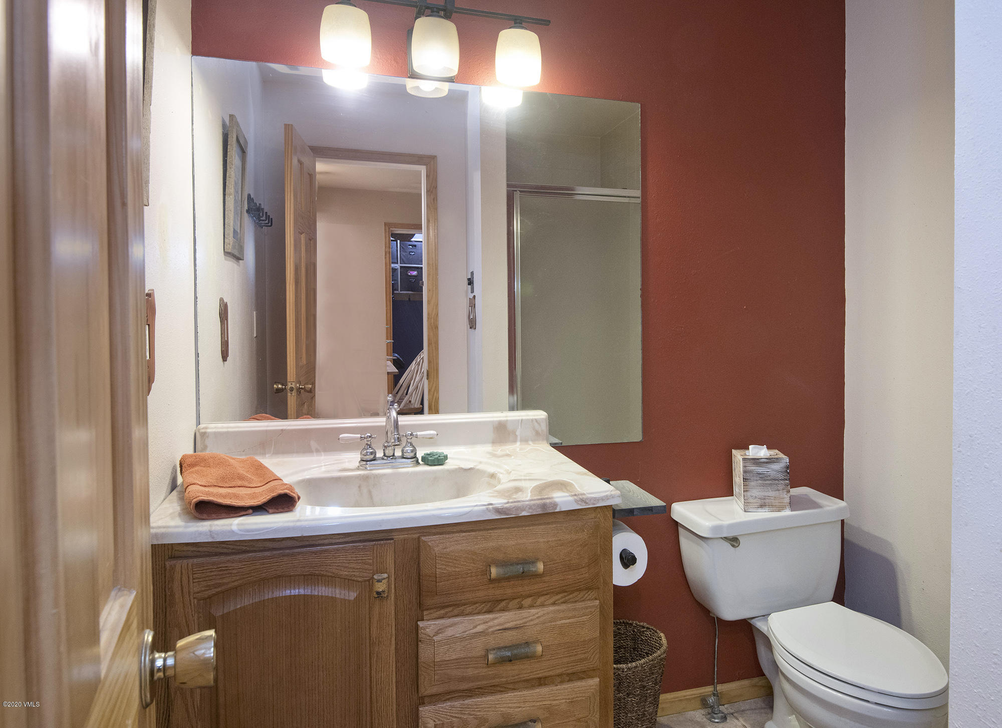 34 Beaver Road, Unit B Avon, CO 81620 - Photo 11 of 34 a bathroom with a granite countertop toilet sink and mirror