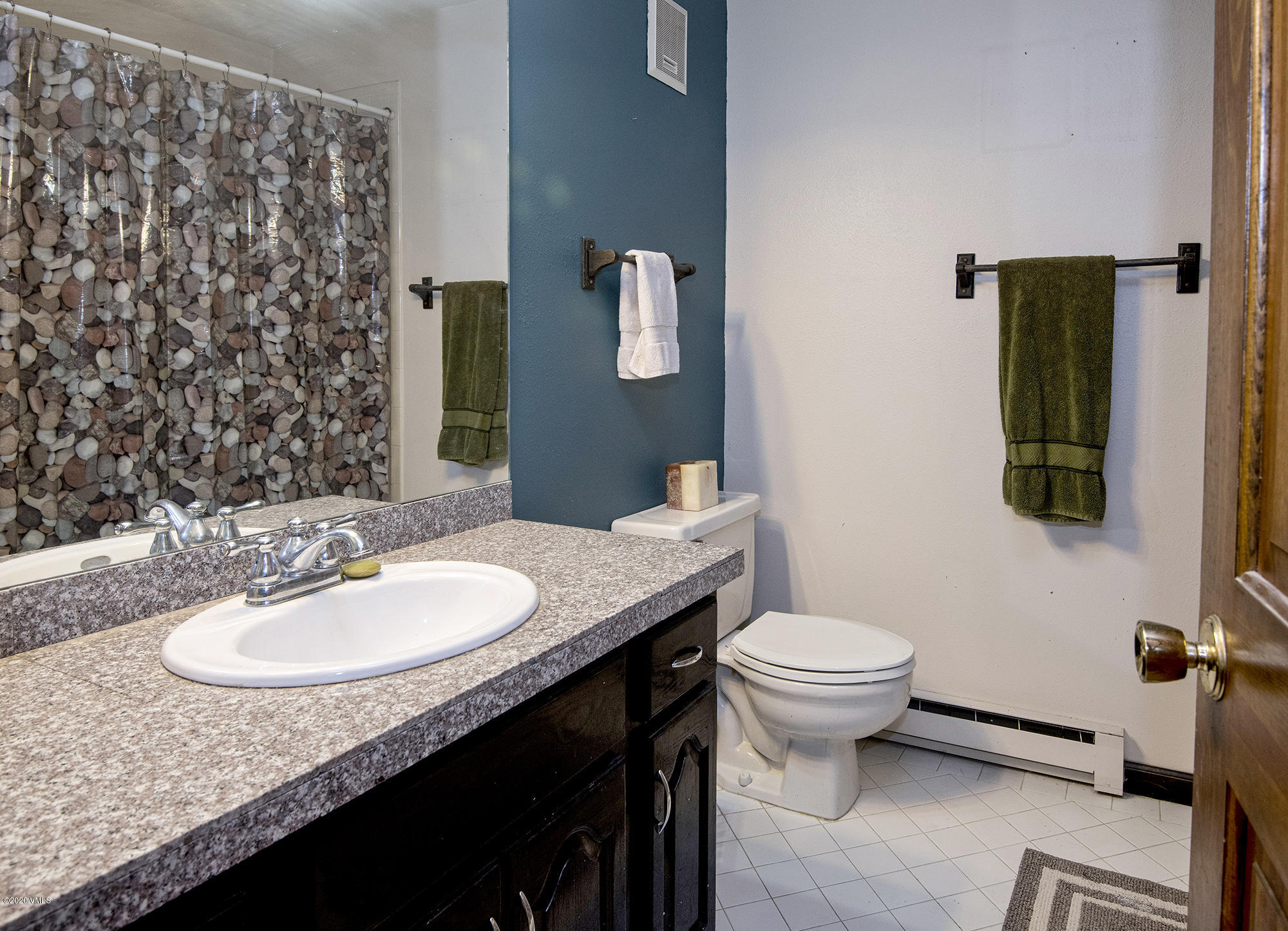 34 Beaver Road, Unit B Avon, CO 81620 - Photo 24 of 34 a bathroom with a granite countertop sink and a mirror