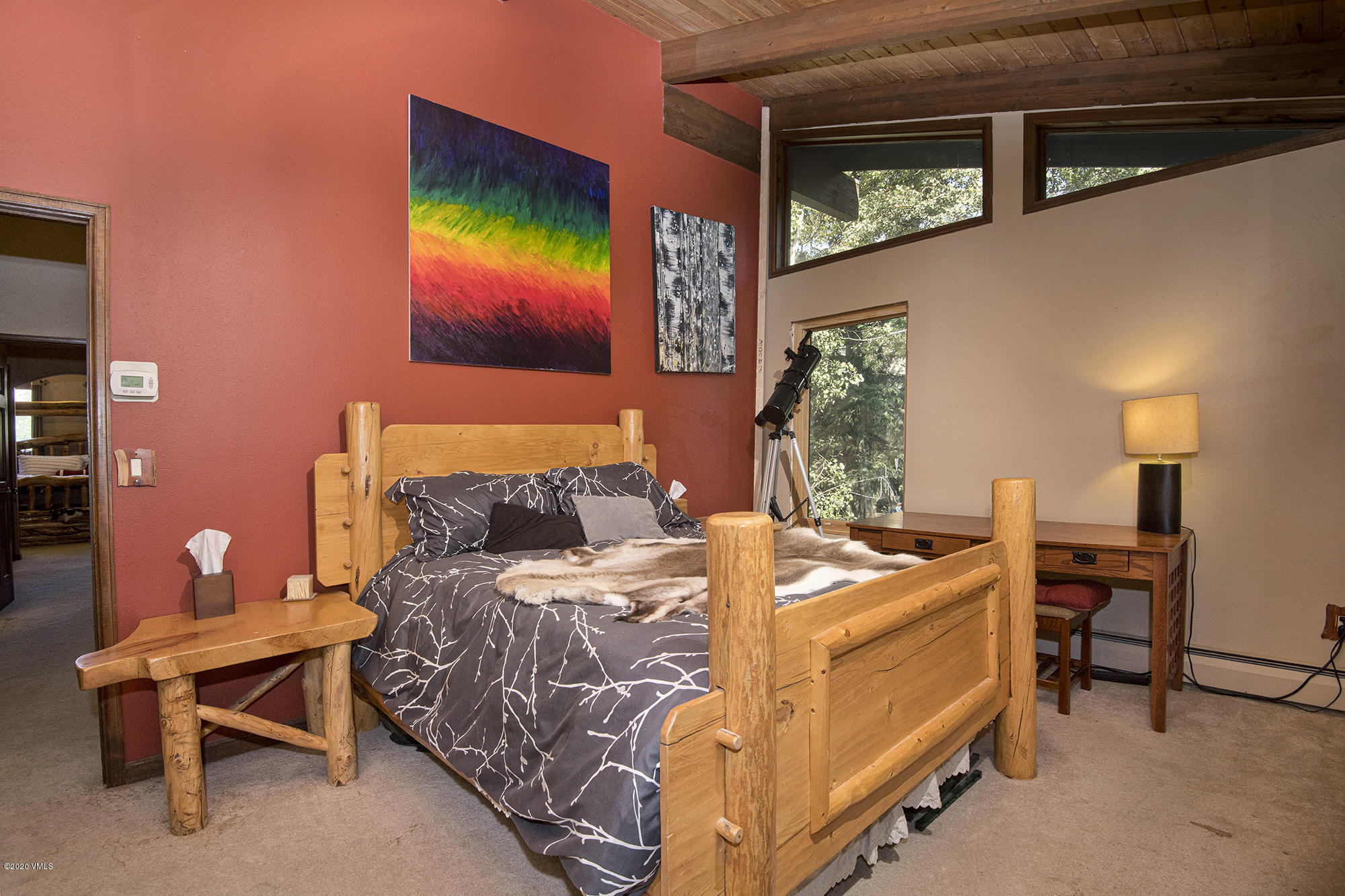 34 Beaver Road, Unit B Avon, CO 81620 - Photo 25 of 34 a bed room with a bed and a chair