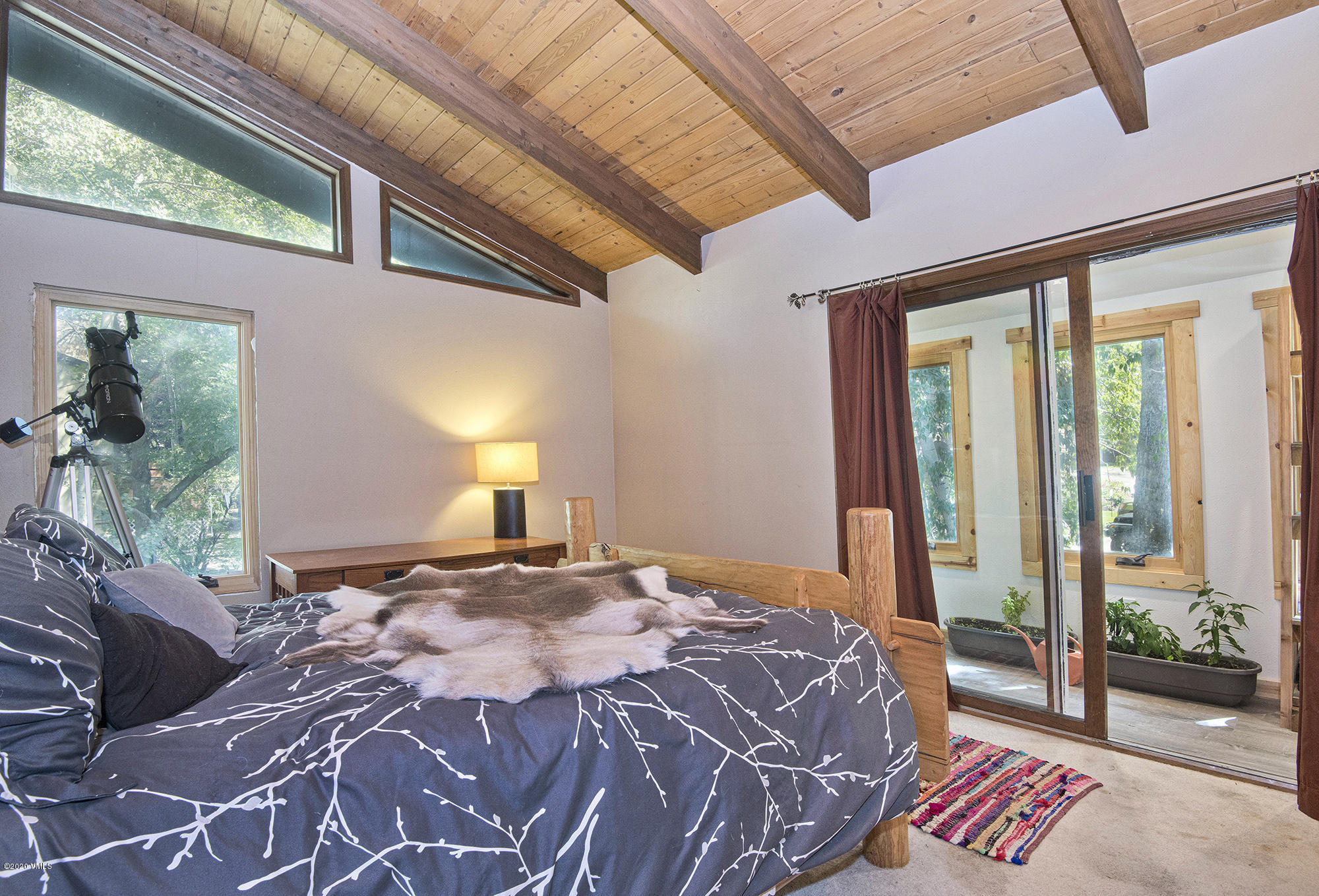 34 Beaver Road, Unit B Avon, CO 81620 - Photo 26 of 34 a bedroom with a bed and a large window