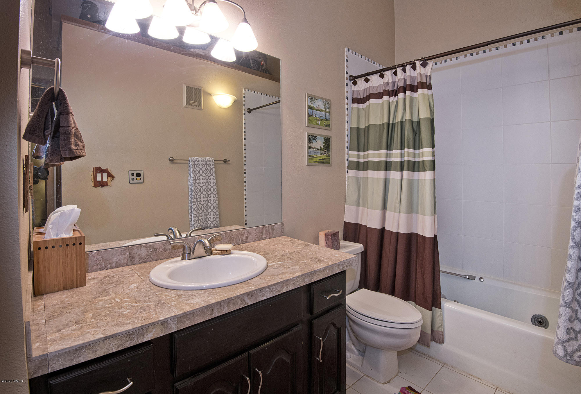 34 Beaver Road, Unit B Avon, CO 81620 - Photo 27 of 34 a bathroom with a sink a toilet a mirror and shower