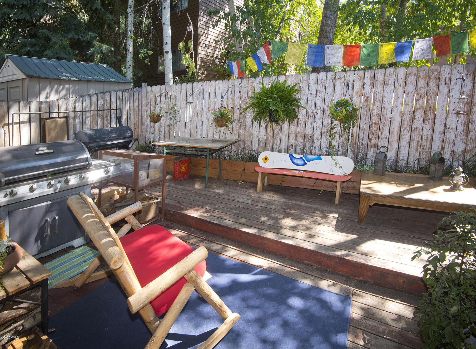 34 Beaver Road, Unit B Avon, CO 81620 - Photo 28 of 34 a backyard of a house with barbeque oven table and chairs
