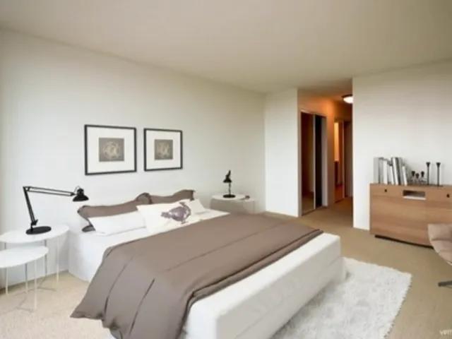 a bedroom with bed and a couch