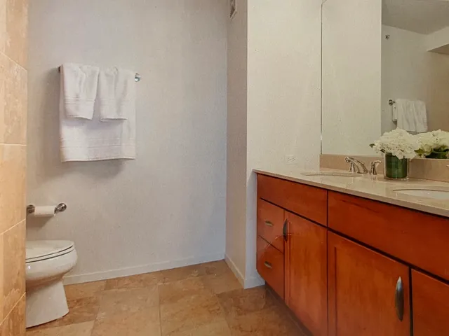 a bathroom with a sink a toilet and a mirror