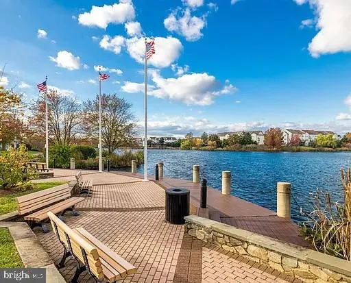 a view of a roof deck with table and chairs