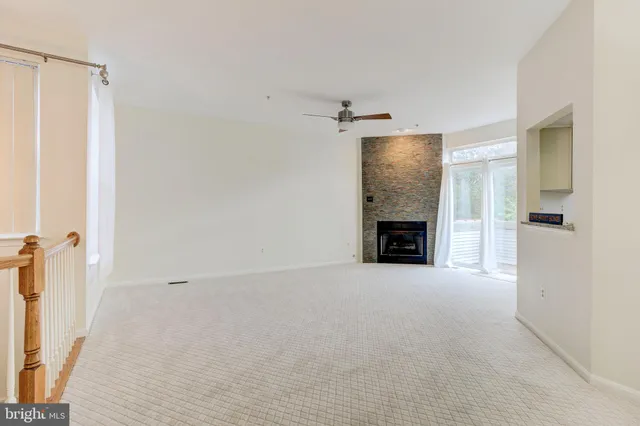 a view of an empty room with a fireplace