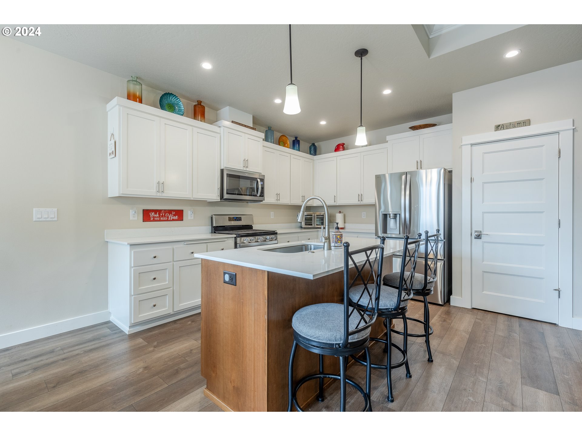 1044 West Olympic Street Springfield, OR 97477 - Photo 12 of 37 a kitchen with kitchen island a sink stove and refrigerator