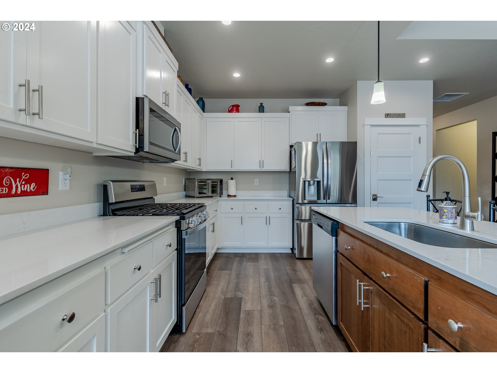 1044 West Olympic Street Springfield, OR 97477 - Photo 13 of 37 a kitchen with cabinets and stainless steel appliances