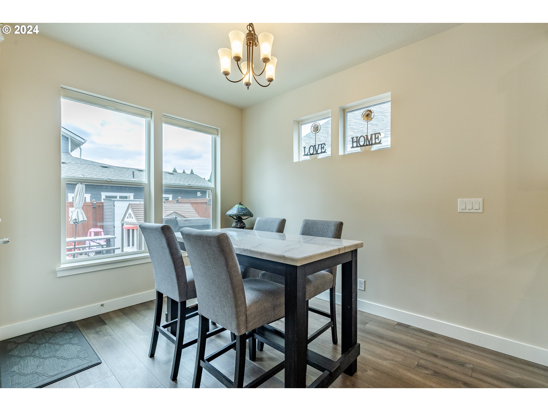1044 West Olympic Street Springfield, OR 97477 - Photo 15 of 37 a view of a dining room with furniture a chandelier and wooden floor