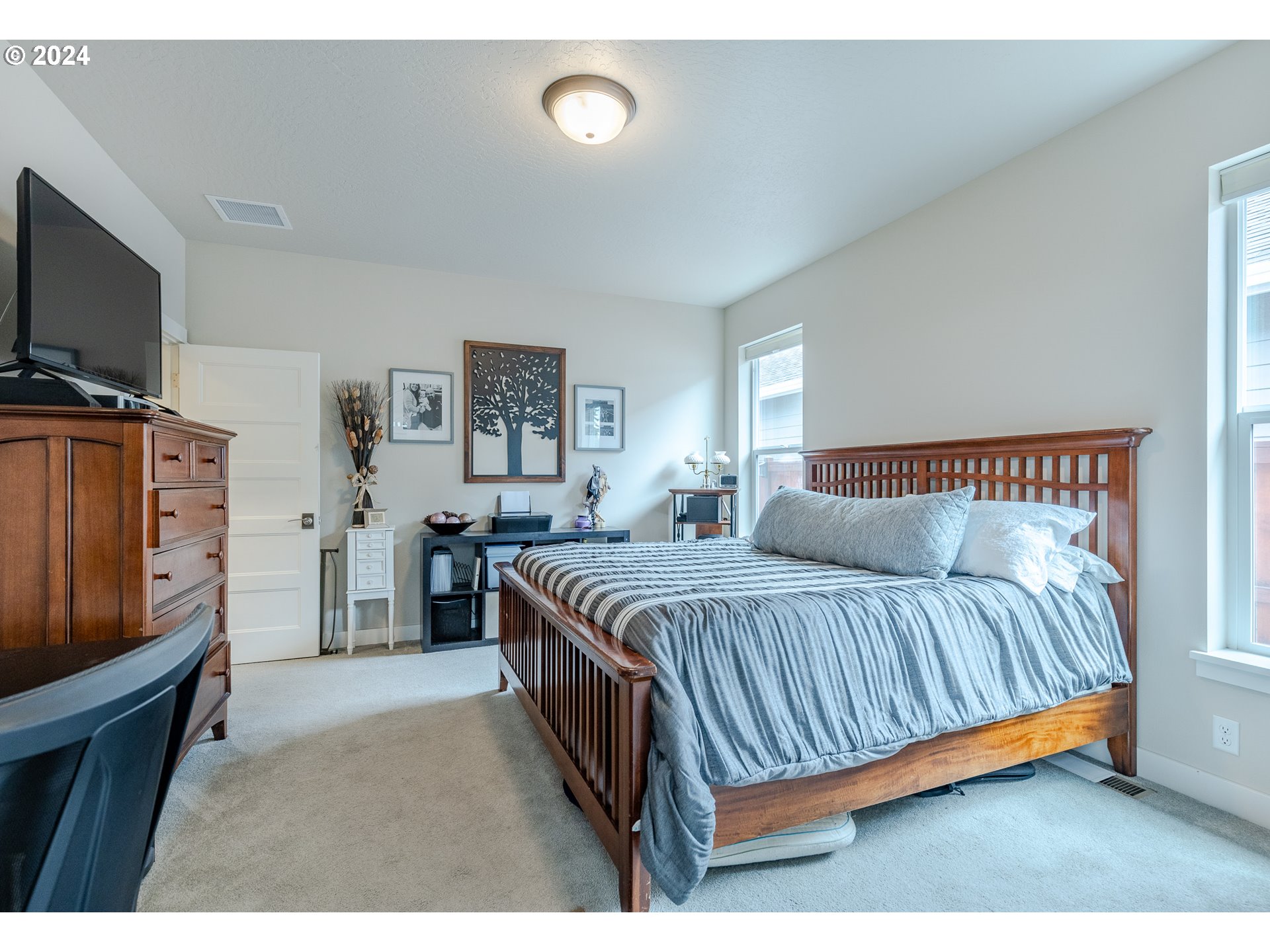1044 West Olympic Street Springfield, OR 97477 - Photo 24 of 37 a bedroom with a bed and a flat screen tv