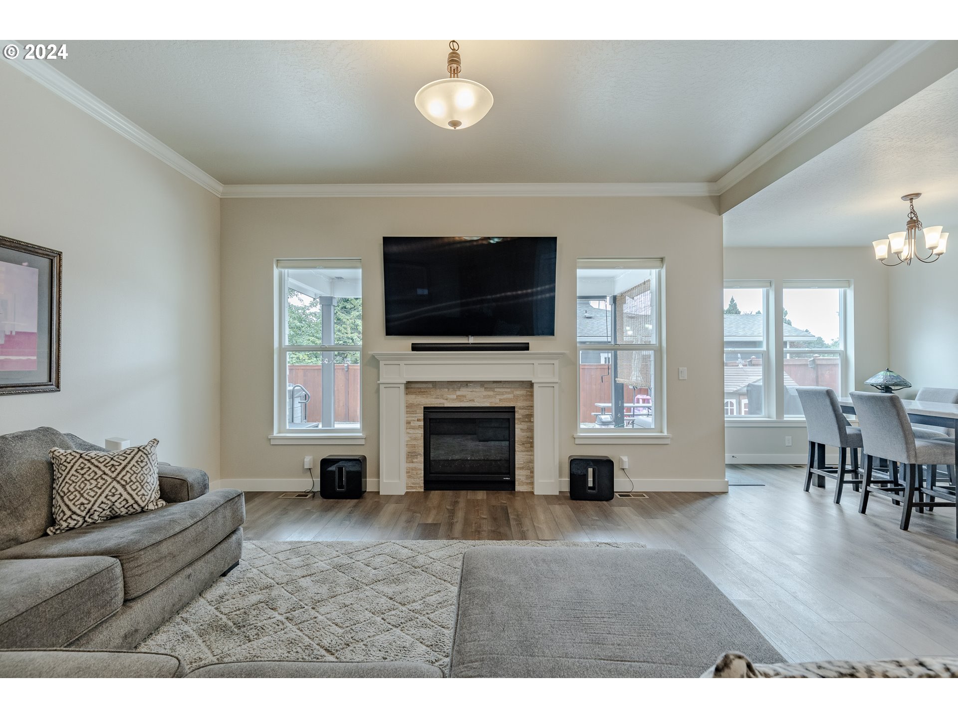1044 West Olympic Street Springfield, OR 97477 - Photo 4 of 37 a living room with furniture a fireplace and a flat screen tv
