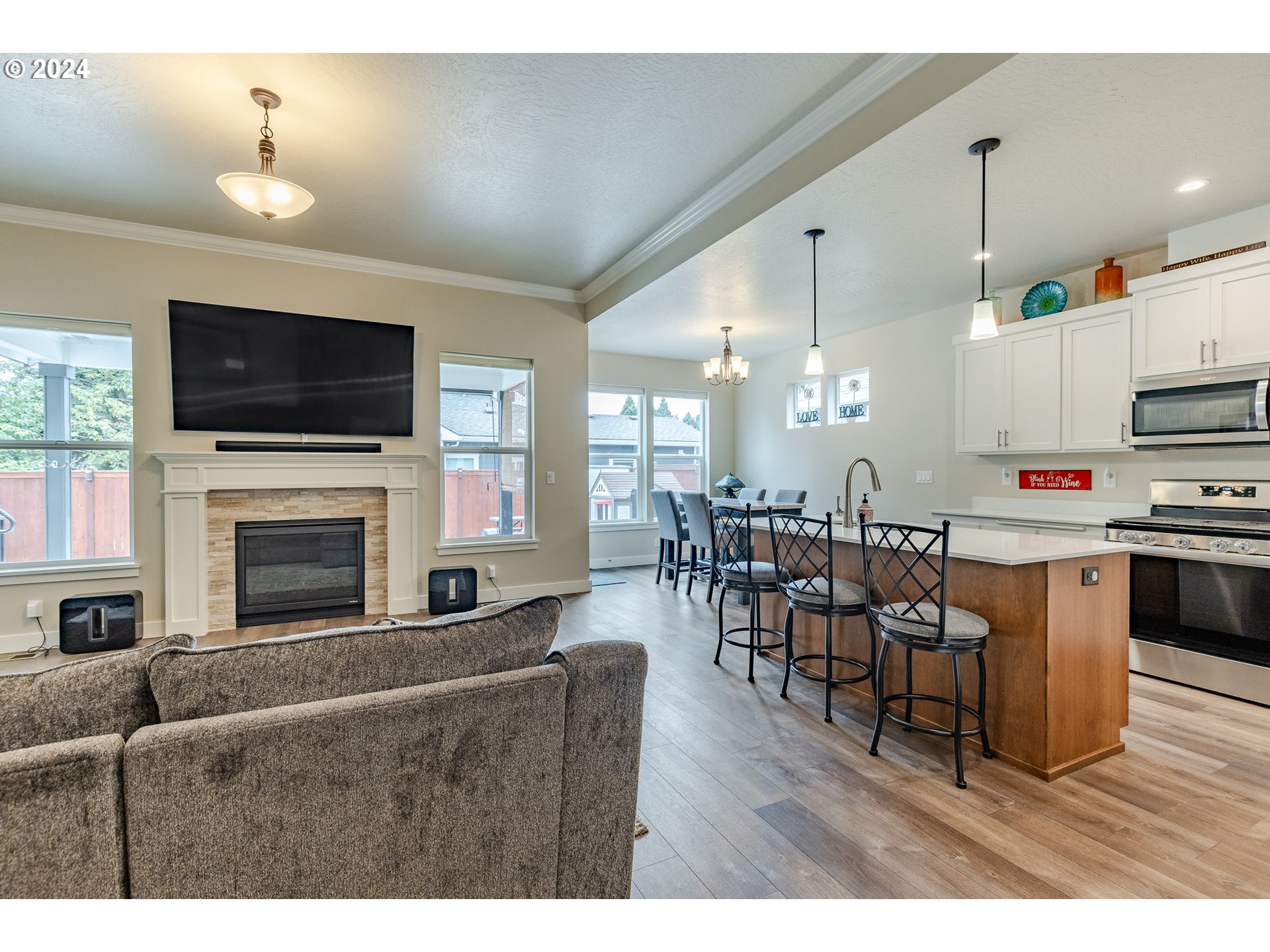 1044 West Olympic Street Springfield, OR 97477 - Photo 9 of 37 a living room with furniture a flat screen tv and a fireplace