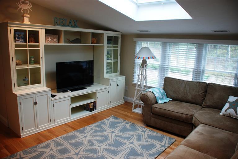 38 Bailey's Path Chatham, MA 02633 - Photo 16 of 20 a living room with furniture a flat screen tv and a fireplace
