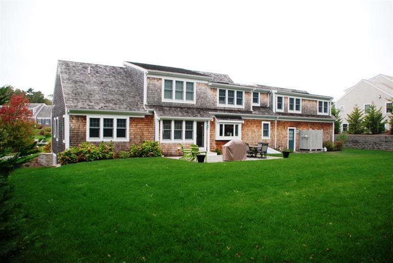 38 Bailey's Path Chatham, MA 02633 - Photo 2 of 20 a front view of a house with a yard table and chairs