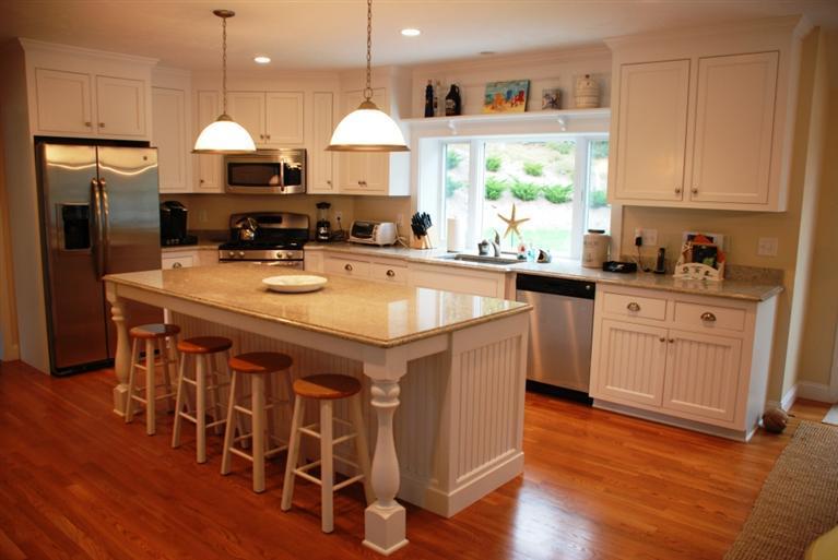 38 Bailey's Path Chatham, MA 02633 - Photo 3 of 20 a kitchen with stainless steel appliances granite countertop a sink a stove a refrigerator and island with wooden floor