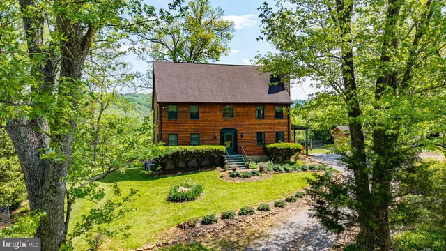 a aerial view of a house with yard and patio