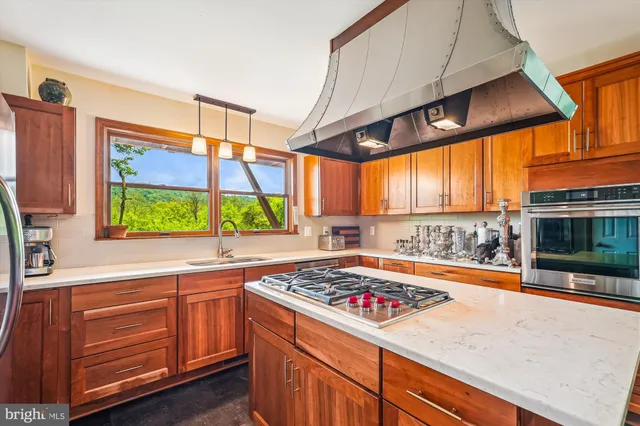 a kitchen with a sink a counter top space and cabinets
