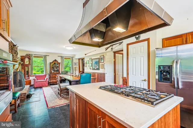 a view of a kitchen with granite countertop a stove and a refrigerator