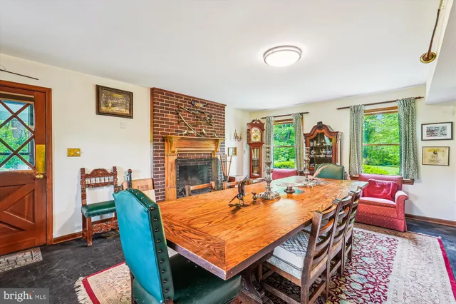 a dining room with furniture and a large window
