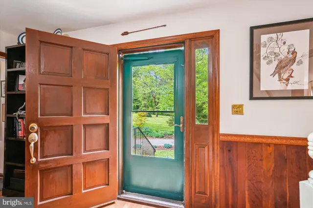 a living room with furniture a rug and a chandelier